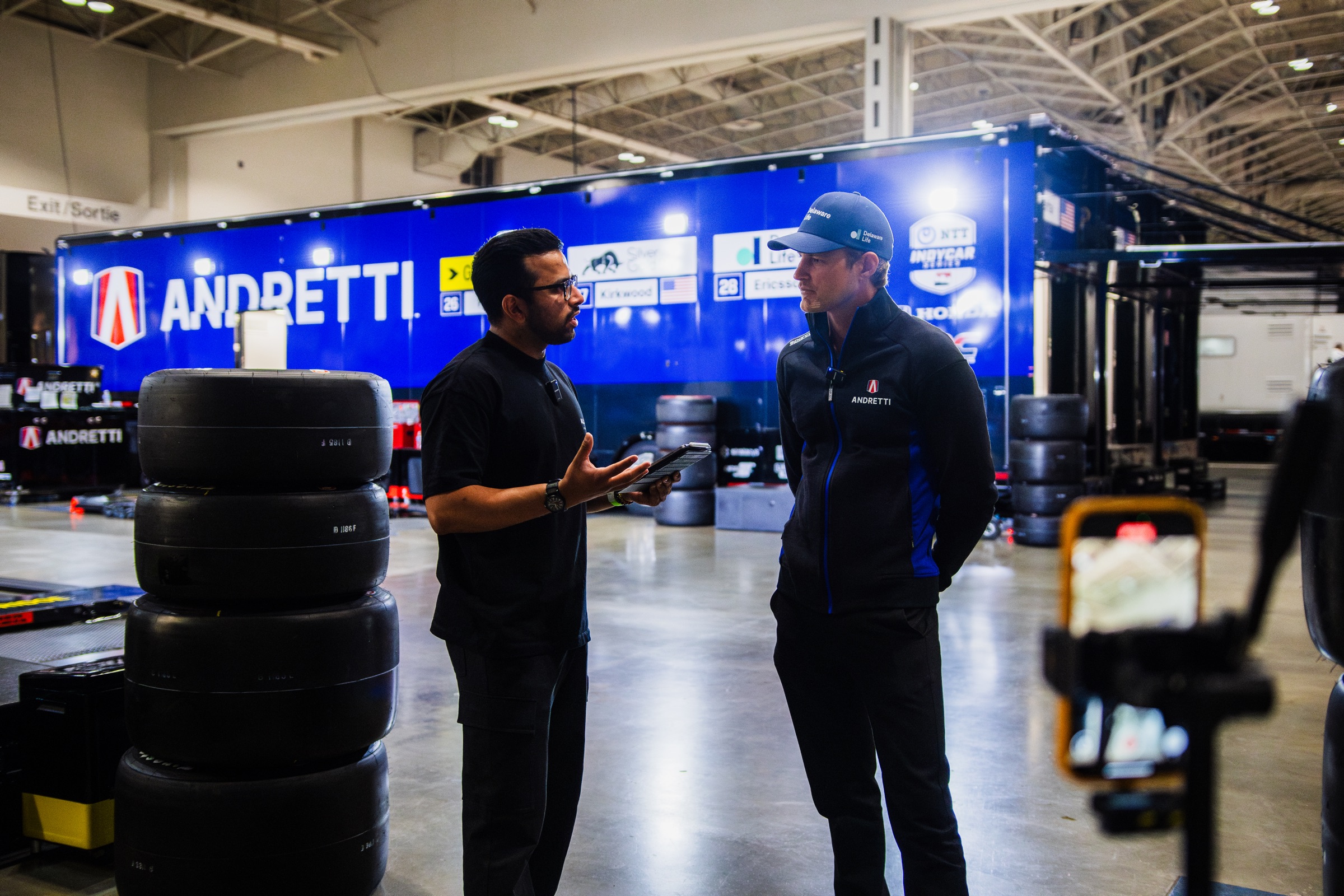 Sachin Jha interviewing an IndyCar driver in the paddock
